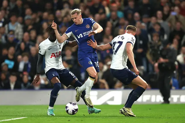 Mykhaylo Mudryk of Chelsea is challenged by Yves Bissouma and Micky van de Ven of Tottenham Hotspur