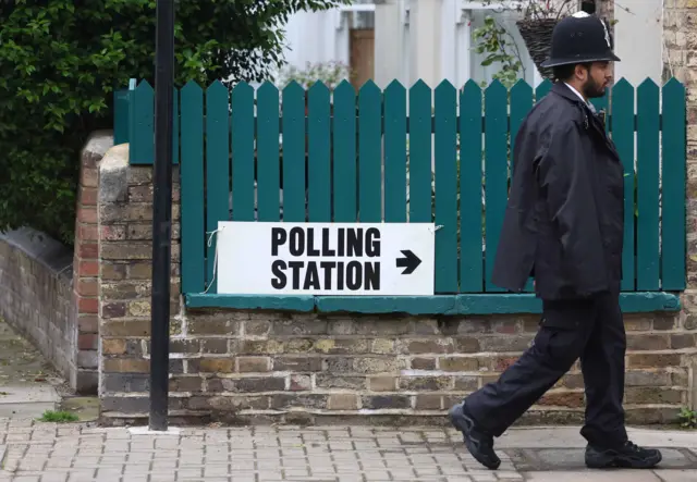 A policeman arrives at a polling station in London