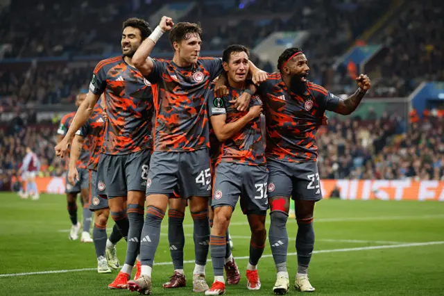 Olympiakos players celebrate a goal together