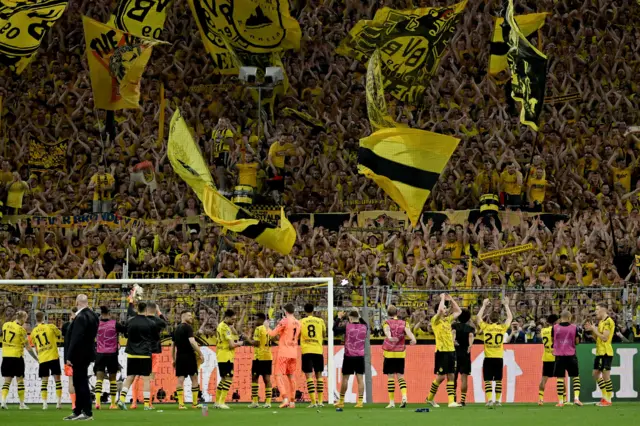 Borussia Dortmund players salute the Yellow Wall