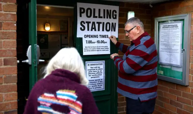 A lady enters a polling station during local elections in Keele