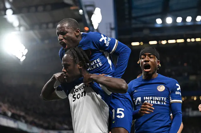 Trevoh Chalobah of Chelsea celebrates scoring his team's first goal, whilst revealing a shirt which reads "Jehovah's Son", with teammates Nicolas Jackson and Noni Madueke