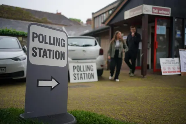 Voters leave the polling station at St Alban's Church, south London