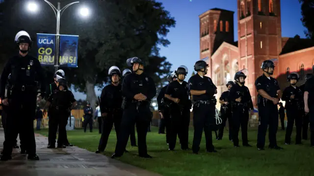 Several police officers gather near Royce Hall, gearing up to enter the pro-Palestine encampment on campus.