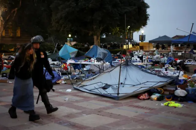 A protester is detained at a pro-Palestinian protest encampment at UCLA