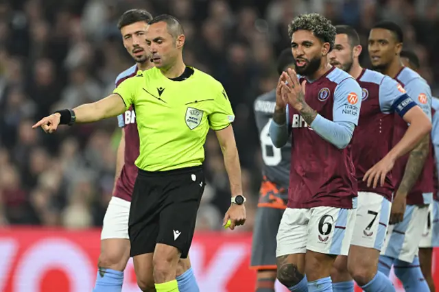 Italian referee Marco Guida points to the penalty spot after a handball