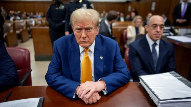 Trump sits in court