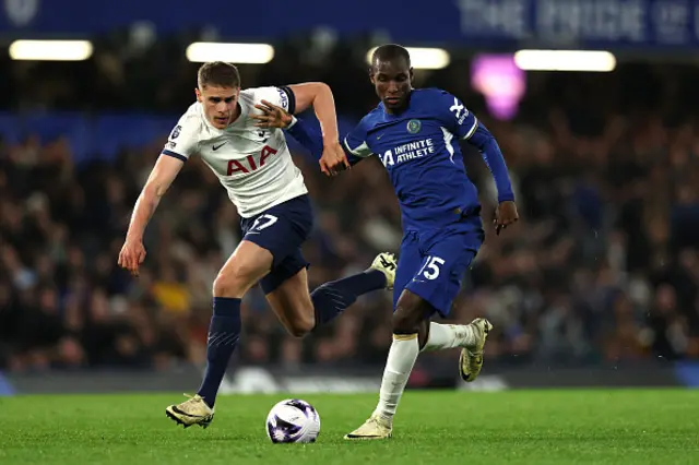 Nicolas Jackson of Chelsea runs with the ball whilst under pressure from Micky van de Ven of Tottenham Hotspur