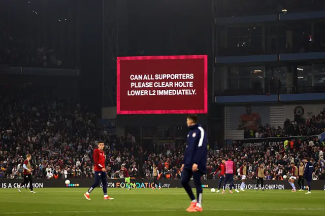 The LED board shows the message "can all supporters please clear Holte Lower L2 immediately"