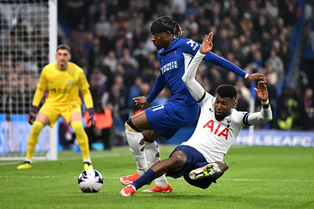 Emerson of Tottenham Hotspur is challenged by Noni Madueke of Chelsea