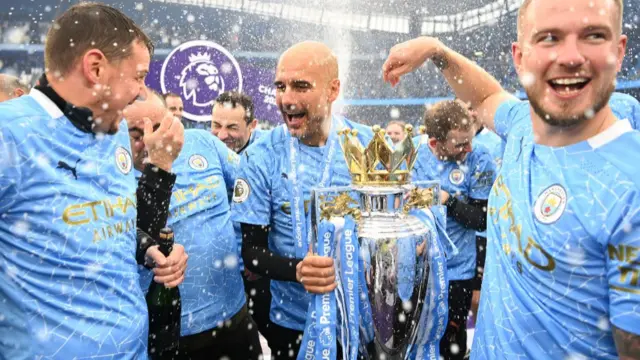 Pep Guardiola with the Premier League trophy in 2021