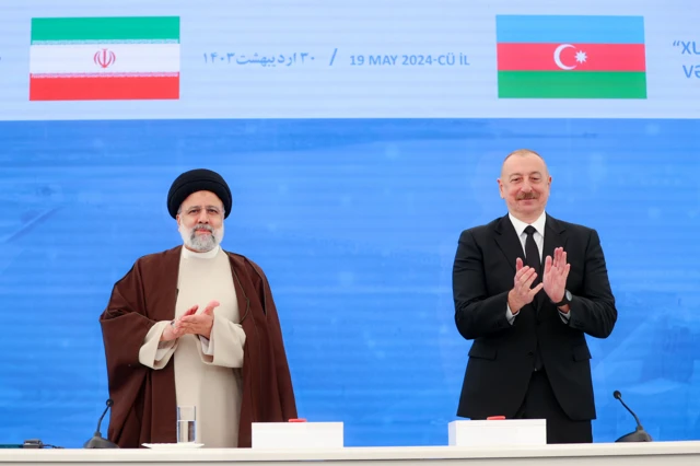 Handout image supplied by the Office of the President of the Islamic Republic of Iran showing President Ebrahim Raisi meeting with Azerbaijani President Ilham Aliyev as they inaugurate the Qiz Qalasi Dam, constructed on the Aras River on the joint borders between Iran and Azerbaijan