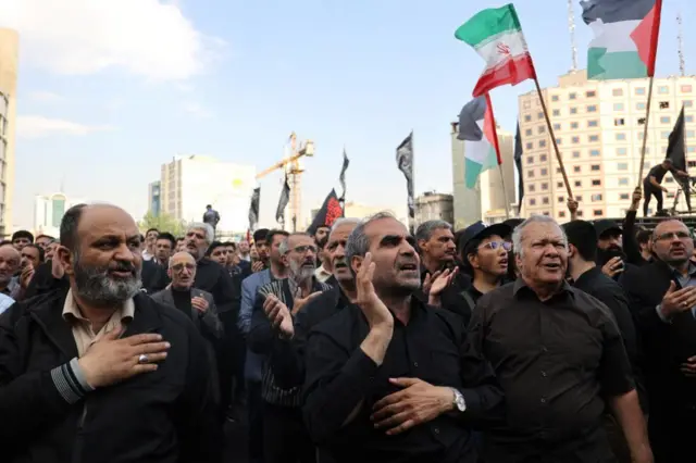 People gather to mourn for the death of the late Iran's President Ebrahim Raisi, in Tehran