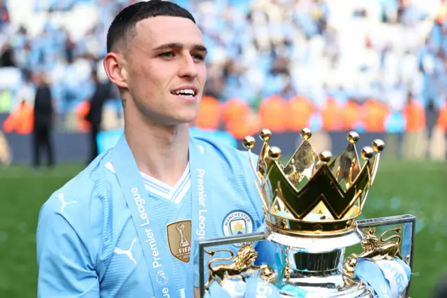 Phil Foden with the Premier League trophy