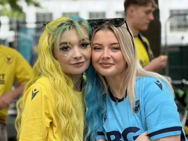 Two Oxford fans pose outside Wembley stadium