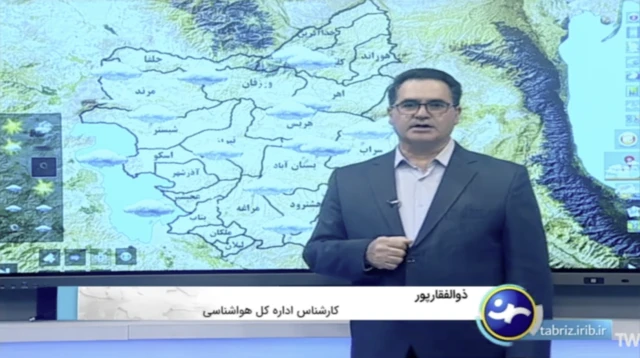 A weather forecaster standing in front of a weather map. It has a screenshot from the Sahand TV broadcast.