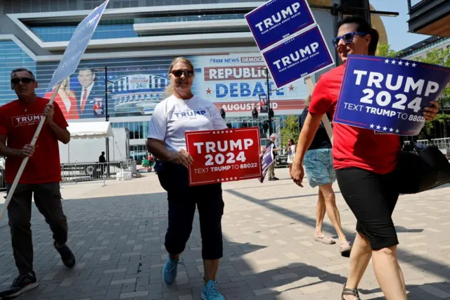 Trump supporters hold signs saying 'Trump 2024'