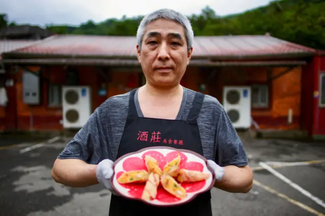 Chef Tong Shi-min from the Jiu Zhuang Mei Shi restaurant presents a plate of sweet potato-kumquat rolls