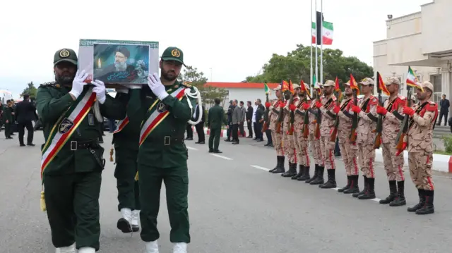 Soldiers carry the coffin of the late Iranian President Ebrahim Raisi, during his funeral ceremony in Tabriz