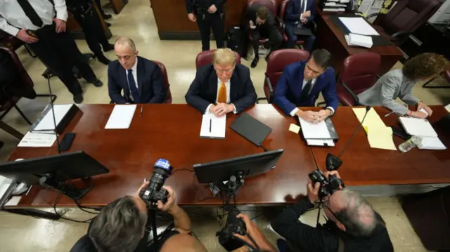 Former US President Donald Trump sits in the courtroom as he arrives for his trial for allegedly covering up hush money payments at Manhattan Criminal Court on May 21, 2024 in New York City.