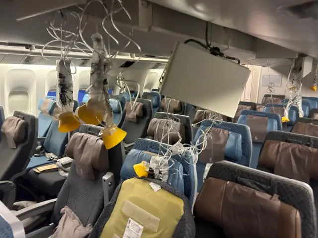 Oxygen masks and parts of the plane's interior appear to be dangling from walls and ceiling