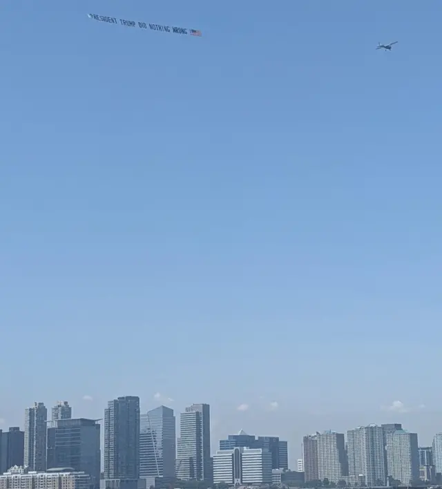 A plane flying a banner over New York