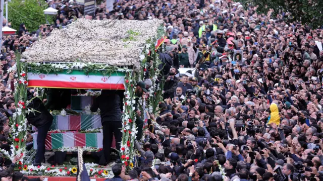 Iranian mourners pay their respects to late president Ebrahim Raisi and his aides during a funeral procession in Tabriz