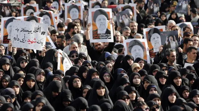 Iranians, among them women clad in black chadors, hold posters of late Iranian President Ebrahim Raisi as they take part in a mourning ceremony in Tehran, Iran, 20 May 2024