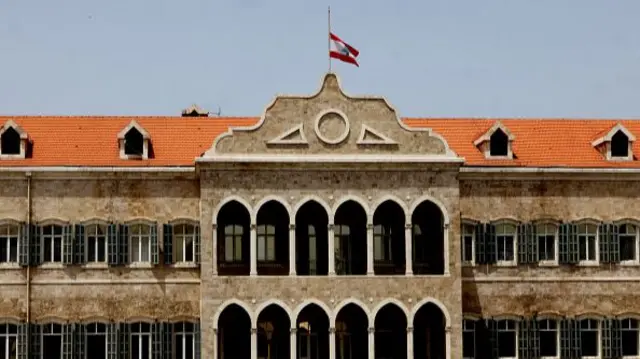 Lebanon's national flag flies at half-mast on the government palace building in Beirut