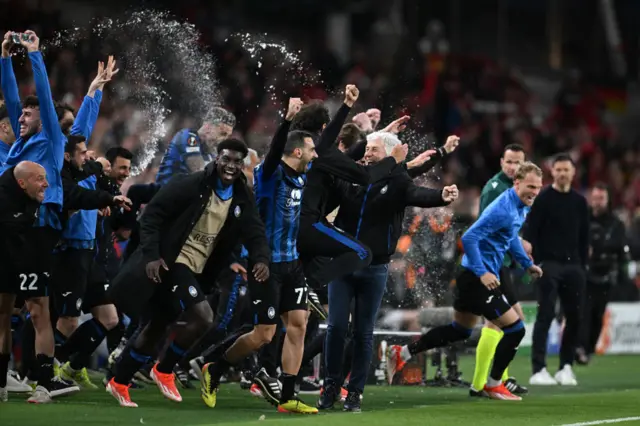 Atalanta players and staff run off the bench at the full time whistle