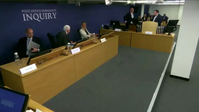 People in the inquiry standing up to leave