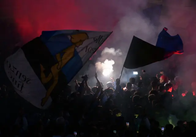 Atalanta fans celebrate the opener back home