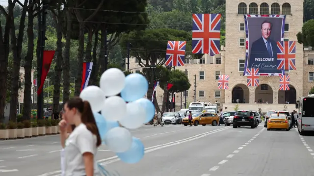 A banner welcoming Foreign Secretary David Cameron hangs on the day of his visit to Tirana, Albania on 22 May