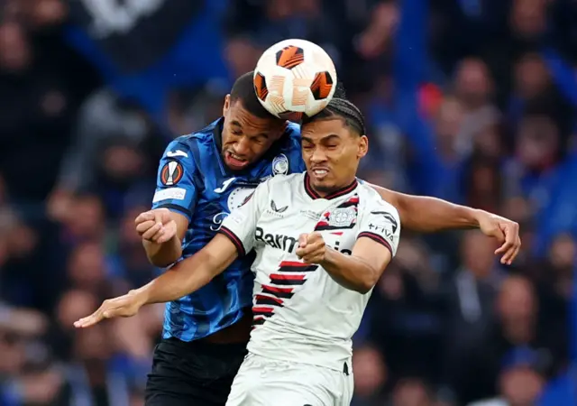 Adli and Hien duel for the ball in the air