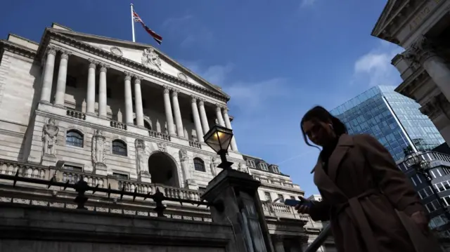 A pedestrian passes the Bank of England in London, Britain, 21 March 2024. The Bank of England will announce interest rate decision on 21 March which is expected to be held at 5.25%