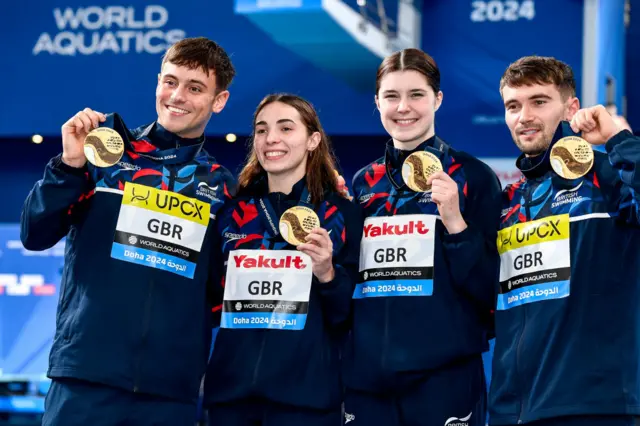 Thomas Daley, Scarlett Mew Jensen, Andrea Spendolini Sirieix and Daniel Goodfellow of Great Britain show the gold medal after competing in the diving Team Eventi Mixed Final