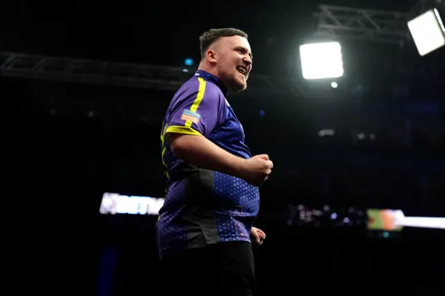 Luke Littler celebrates hitting a nine-darter