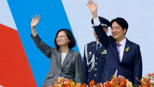 Tsai Ing-wen and Lai Ching-te wave to people during Lai's inauguration ceremony on Monday