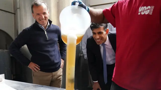 Prime Minister Rishi Sunak and MP for Vale of Glamorgan Alun Cairns watching beer production at the Vale of Glamorgan Brewery in Barry