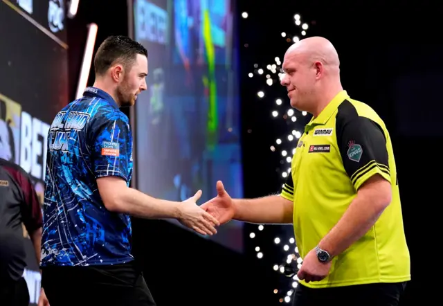 Luke Humphries shakes hands with Michael van Gerwen