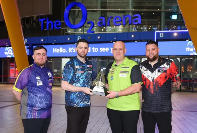 Luke Littler, Luke Humphries, Michael van Gerwen and Michael Smith pose with the Premier League Darts trophy