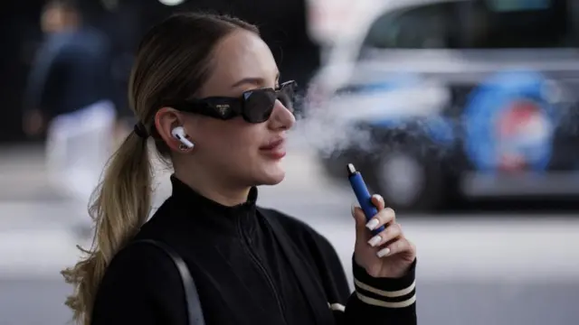 Woman smokes a vape