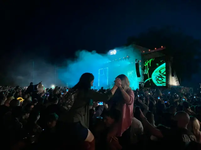 People on each other's shoulders in the crowd