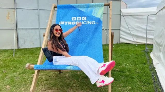 Jasmine Takhar on an oversized deckchair with BBC Introducing written on it