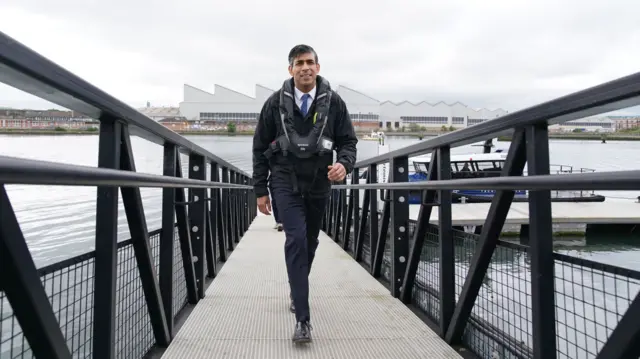 Prime Minister Rishi Sunak during his visit to a maritime technology centre at a dockyard in Northern Ireland