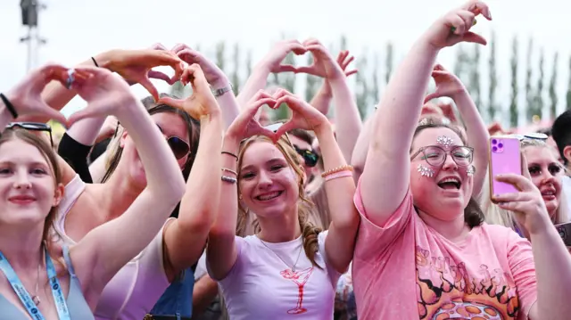 Crowds making a heart sign