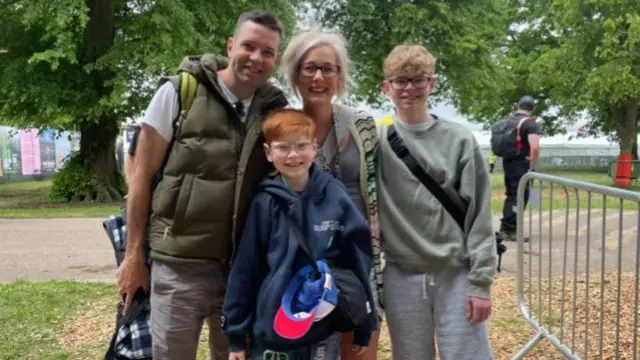 Blackmore family, including parents and two sons, pose for a picture