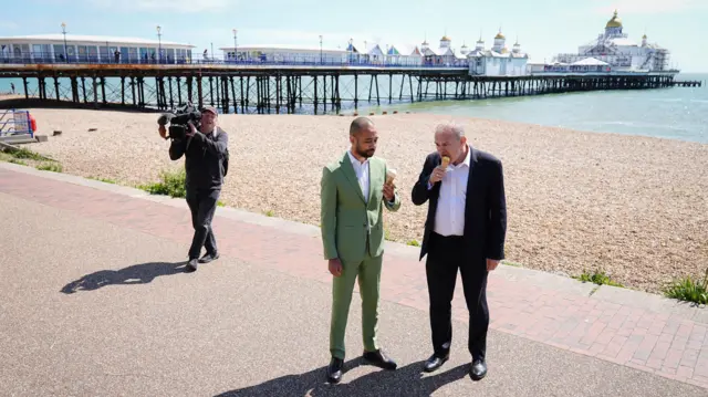 Liberal Democrat leader Sir Ed Davey (right) with Lib Dem candidate for the Eastbourne constituency, Josh Babarinde, eat ice cream on the promenade in Eastbourne, East Sussex