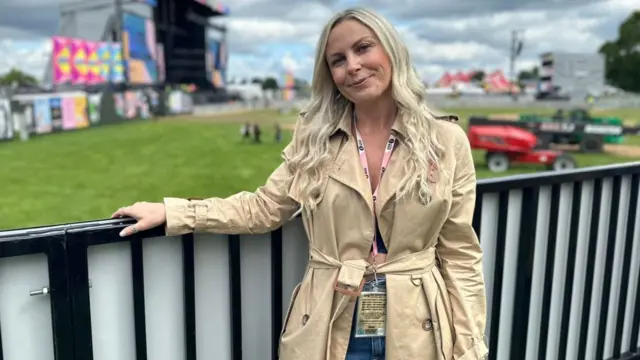 Charlie Hedges stood on a platform near a stage at Radio 1 Big Weekend