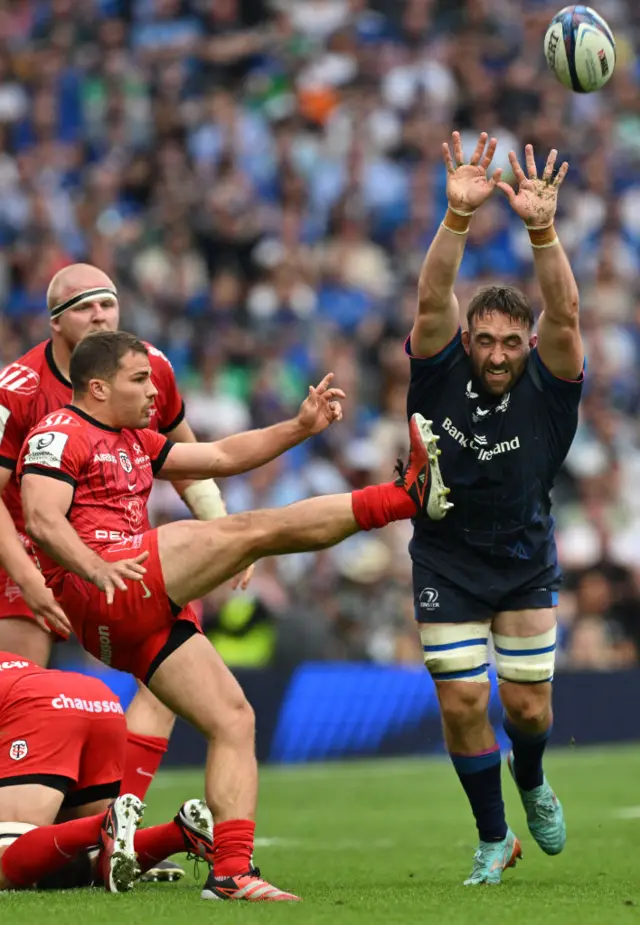 Jack Conan attempts to charge down a kick from Antoine Dupont